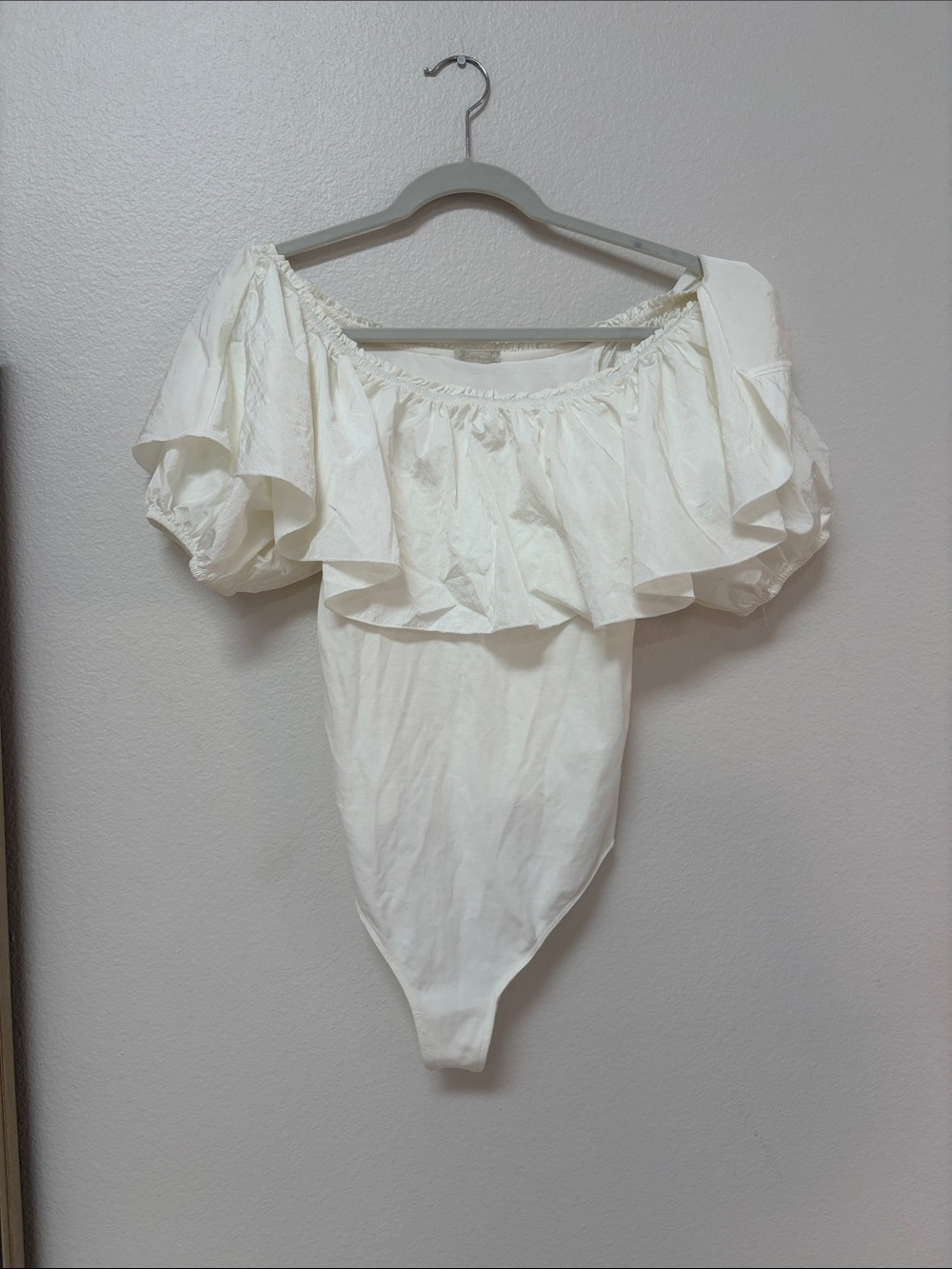 Free People white Poof Goes My Heart off-the-shoulder ruffle bodysuit.